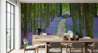 Spring forest wallpaper filled with rich purple-blue flowers and fresh green foliage.