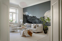 Fjord landscape wall mural with deep blue-gray peaks rising above a smooth reflective fjord.