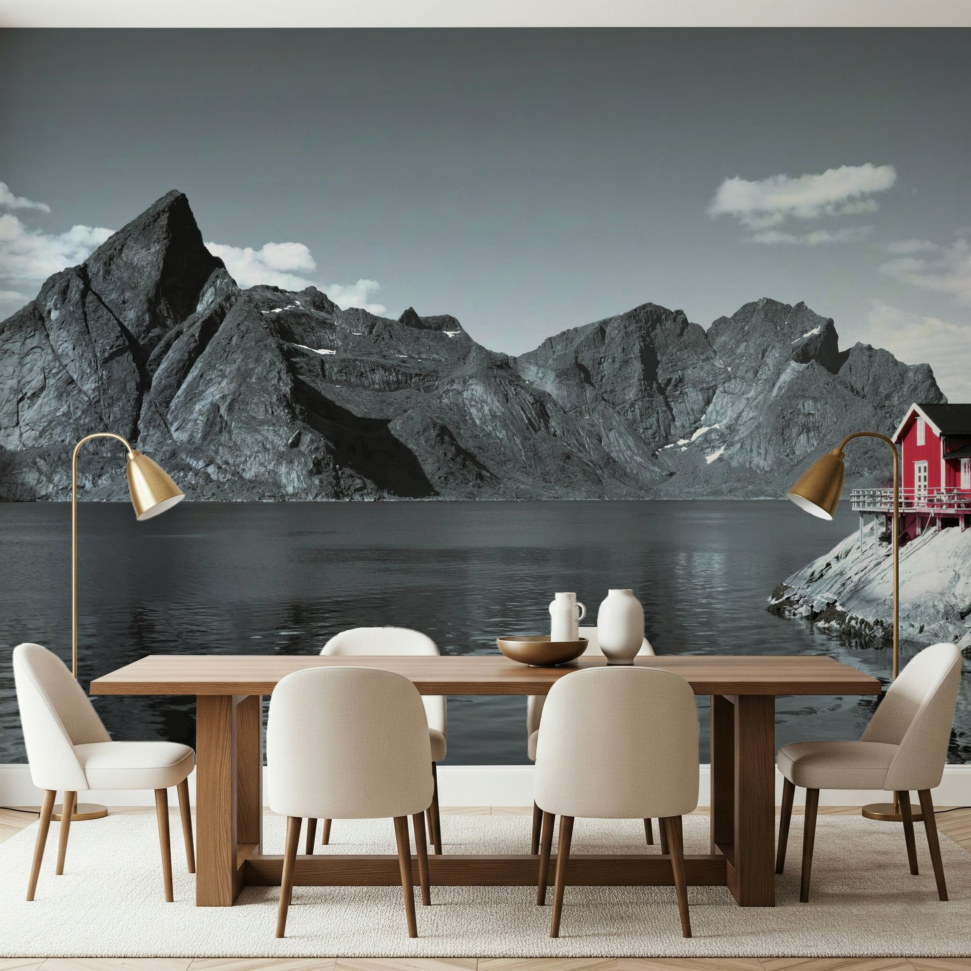 Coastal mountain mural with massive fjord cliffs and a vibrant red cabin at the water's edge.