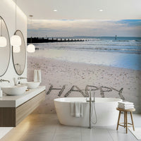 Footprints near word Happy Beach mural inspiring outlook.