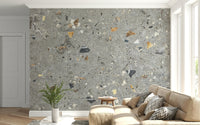 Rugged grey terrazzo wallpaper with fossilized elements.