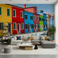 Multicolored Burano accent wallpaper, yellow red blue facade, summer sunshine.