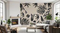 Organic fern wall mural behind a living room sofa with soft beige contrast