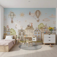 City Cats wall mural in a kids room with pastel buildings and hot air balloons