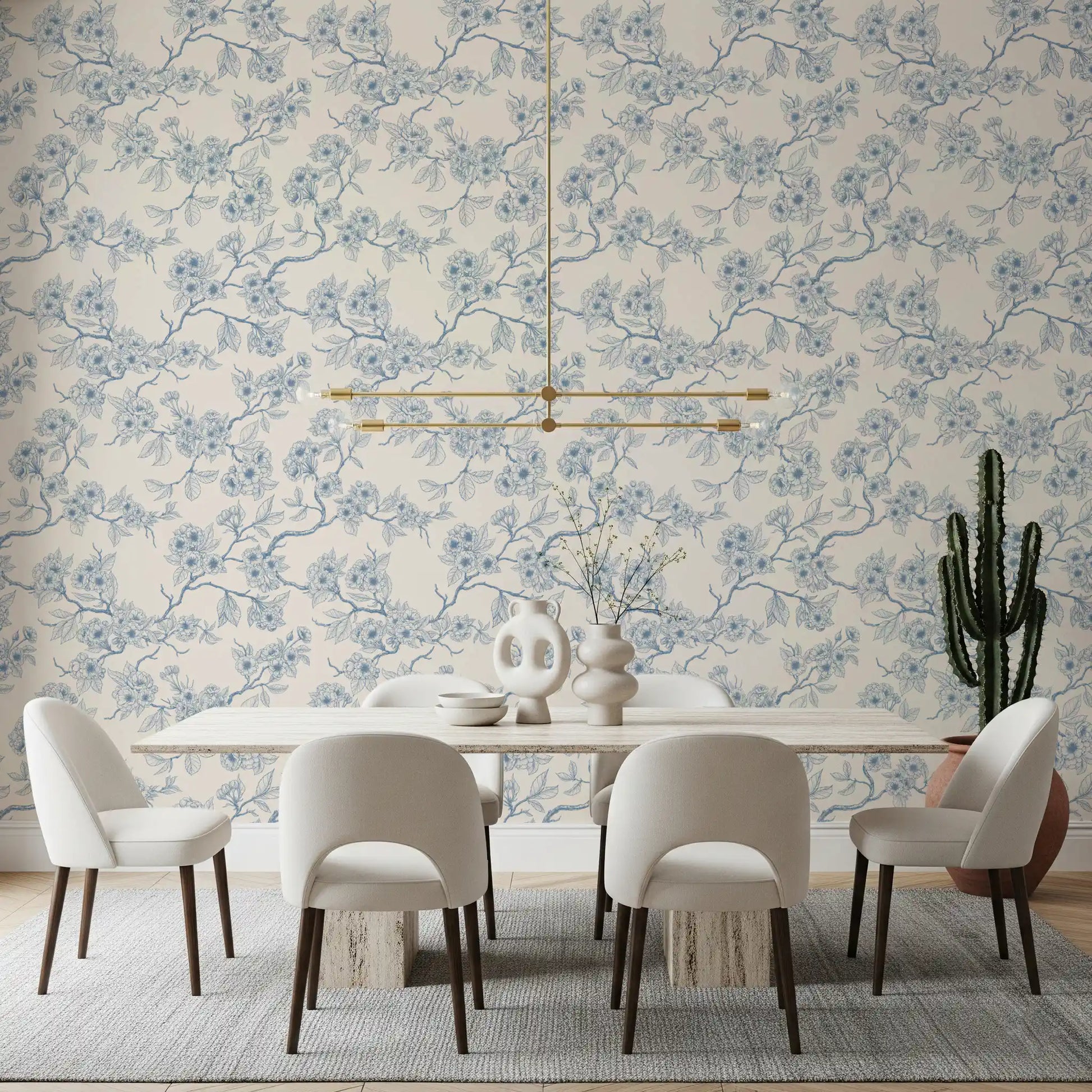 Dining room setup with cherry blossom branch wallpaper in soft blue tones