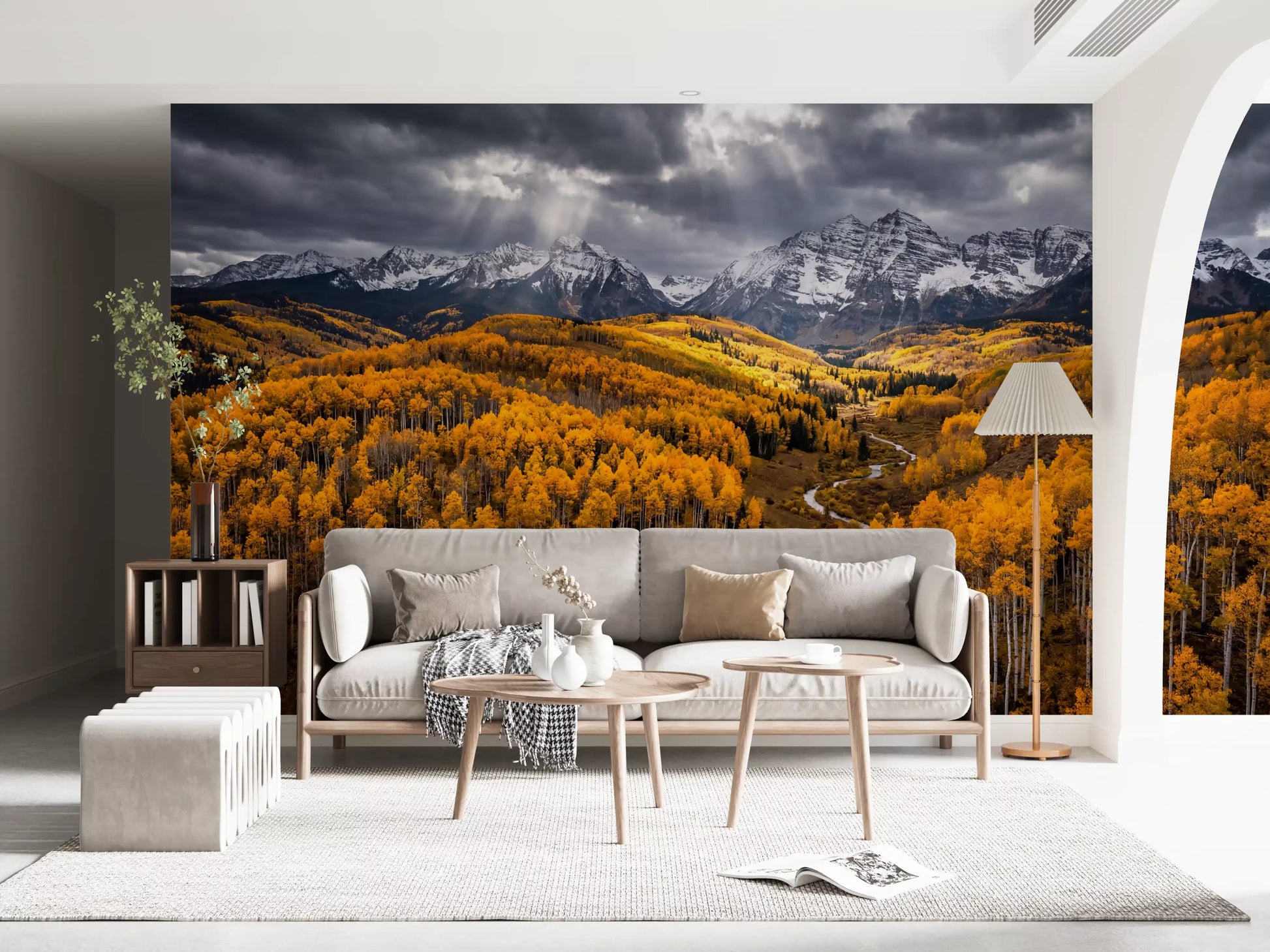 Living room wall mural showing golden forest valley slopes and storm-lit mountain peaks