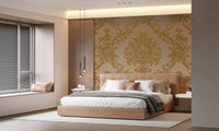 Bedroom with gilded scrollwork mural in warm beige gold finish