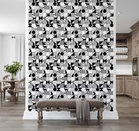 Living room wall finished in Monochrome Cat Maze wallpaper with black feline tiles