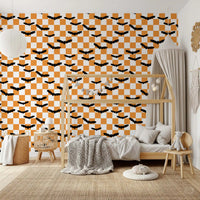 Bedroom wall showing Spooky Checkerboard Bats Wallpaper with black bats