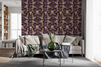 A calm repeat forms this botanical floral wallpaper with rich plum tones