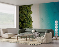 Living room clad in coastal wall mural with aqua water and dense palm canopy