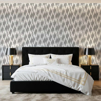 Bedroom styled with intricate teardrop geometric wallpaper in gray and white