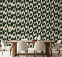 Modern crest wallpaper applied across the dining room in forest green and cream chevron