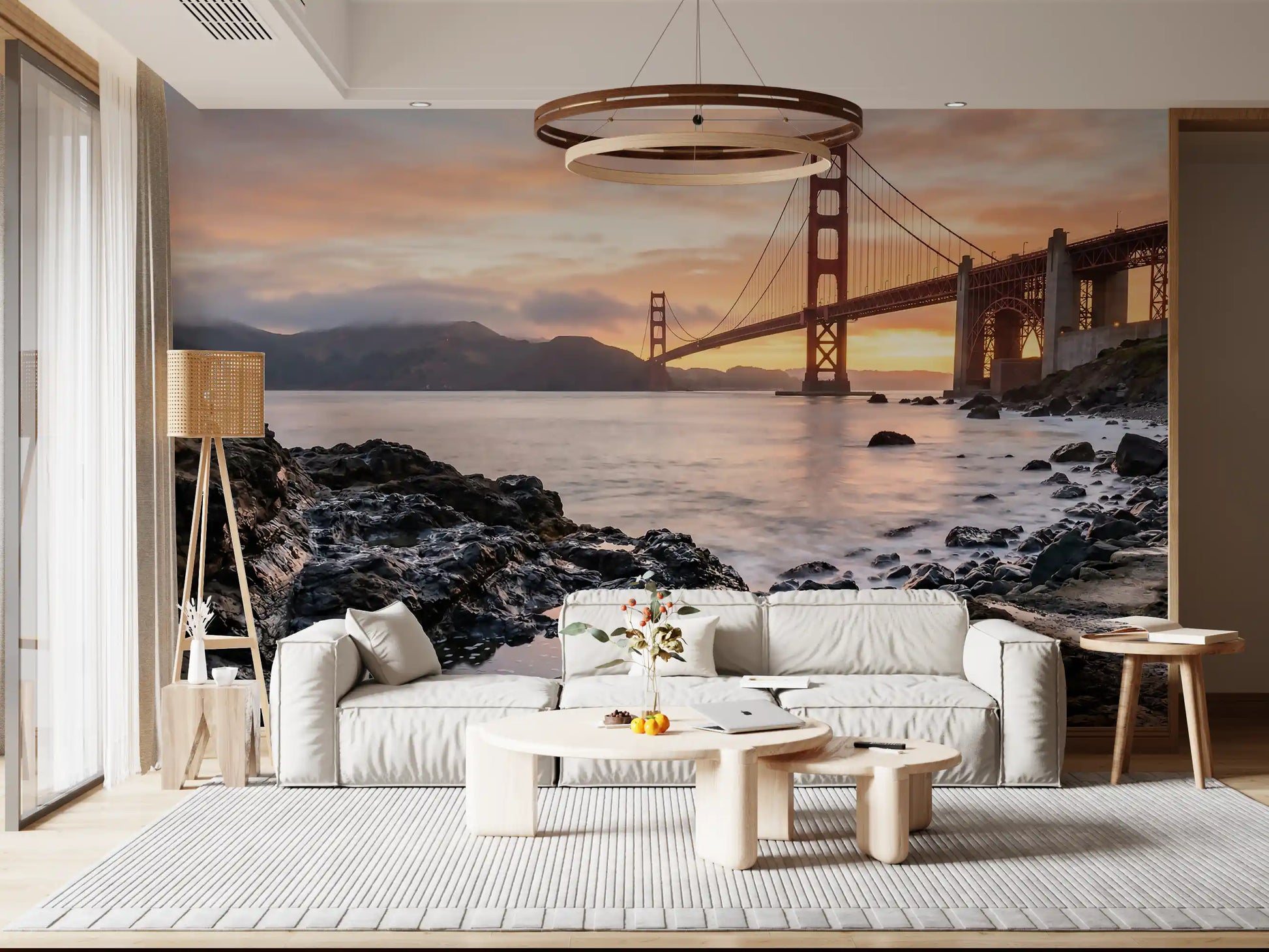 Warm peachy-gold light floods the sky behind the suspended bridge on the wall mural