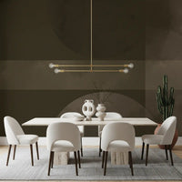 Warm dining room illuminated alongside a dark abstract wall mural.