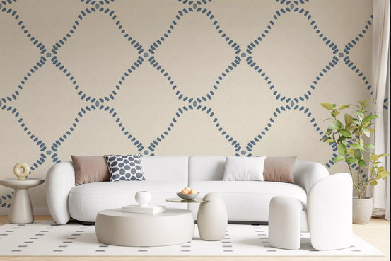 Dotted Lattice wallpaper gives a living room a calm coastal-boho backdrop.
