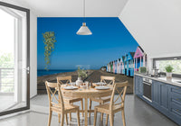 A row of pastel huts recedes down the promenade in this Serenity wall mural