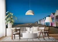 Clear blue sky fills the upper half of the Beach Hut Serenity wall mural