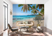 Coconut palms arc over white sand in the Tropical Beach Paradise wall mural