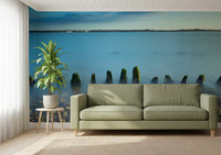 Weathered stakes break a glass-still lake in the Ethereal Coastline landscape wall mural.