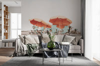 Bright peach umbrellas shade blue loungers on the Coastal Chillout wall mural