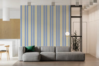 A Living room area with soft blue Scalloped Sky Stripes Wallpaper.