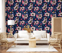 Bright botanical patterns shape the Apple blossom on dark blue wallpaper of a modern lounge.