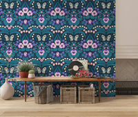 Delicate white lilies and pale blossoms populate the Dollhouse garden wallpaper.