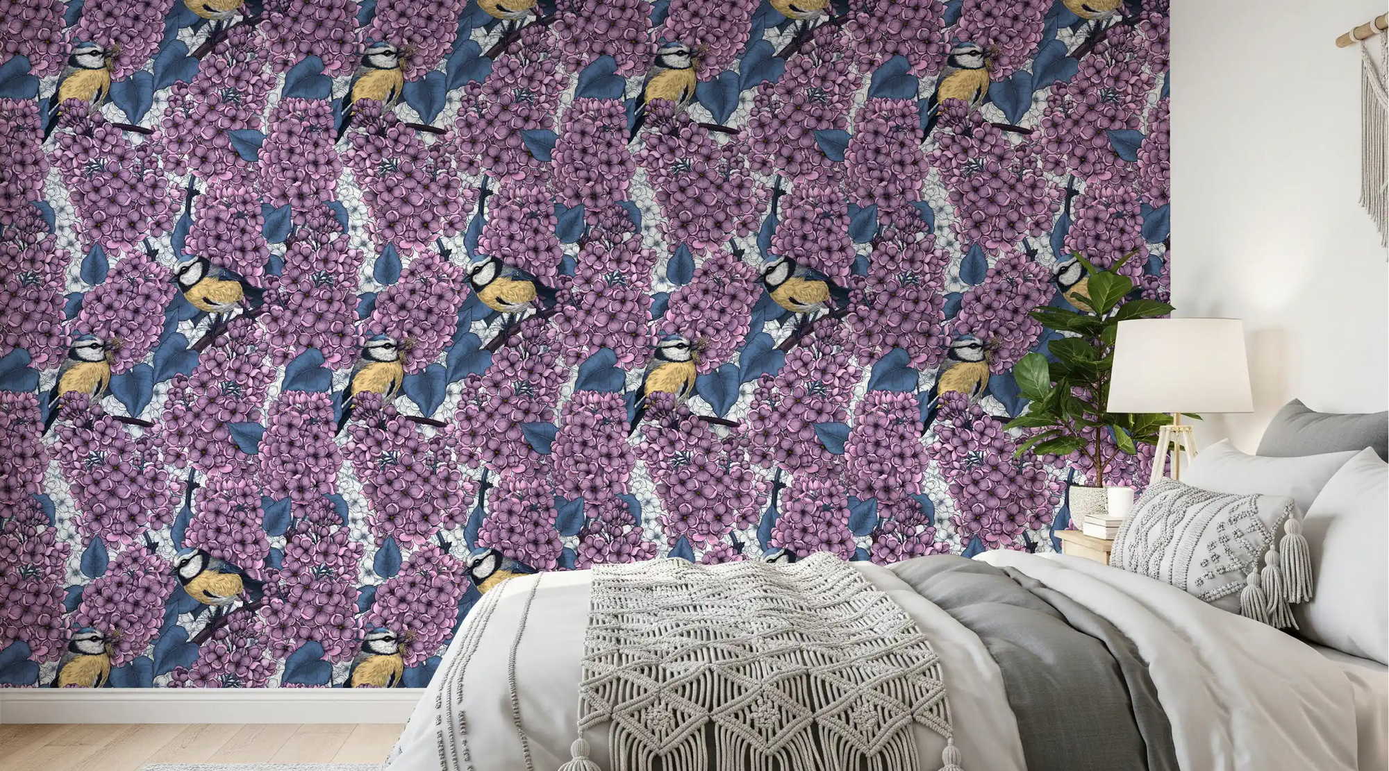 Birds in violet lilac garden wallpaper creates a serene mood in the bedroom.