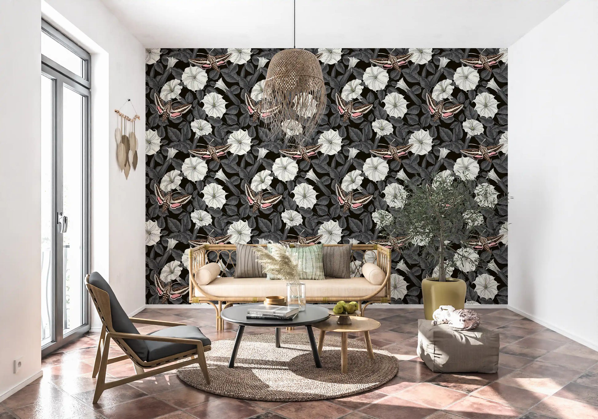 A Living space feels grounded by the dark Moonflowers and sphinx moths wallpaper.