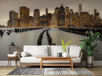 Twin pier pilings curve outward toward Manhattan across the NYC Urban Glow wall mural