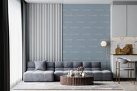 Coastal wallpaper showing soft wave shapes across a dusty blue surface