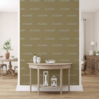 Olive coastal wallpaper carrying small blue waves and minimal styling