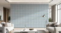 Living room wall with Soft Blue Grid Wallpaper and relaxed boho coastal checks