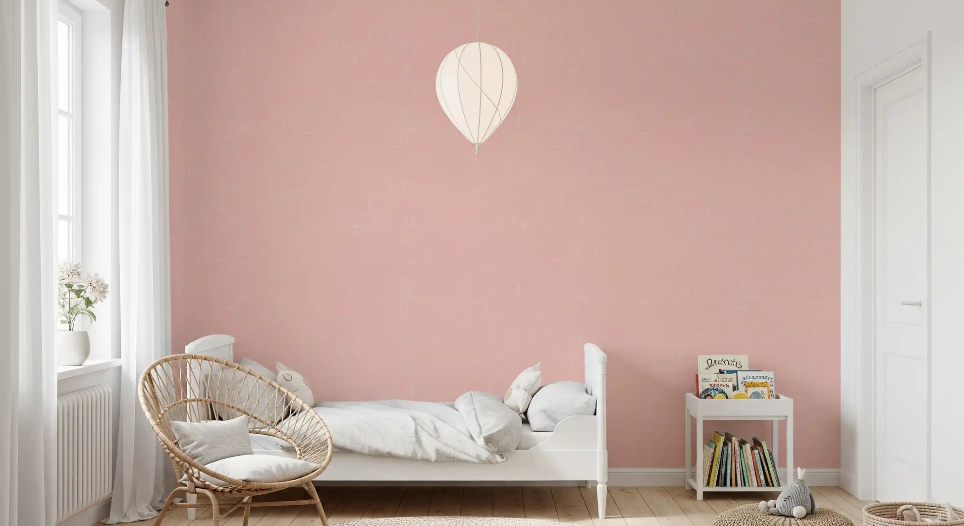 Blush pink linen texture wallpaper on a bedroom accent wall
