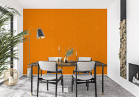 Dining room using linen grain wallpaper in a bright orange tone