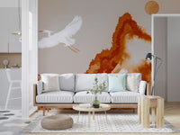 Ochre wall mural featuring bird movement and soft painterly mountain shapes