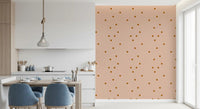 Dining room with blush dotted wallpaper and earthy brown spot accents