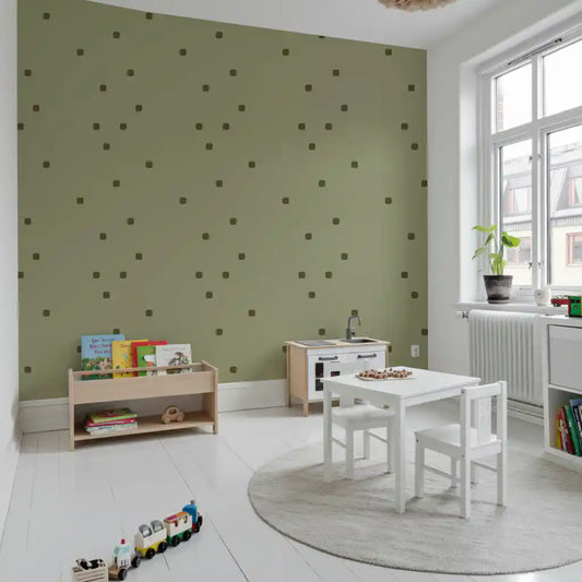 Play area wall showing sage green wallpaper with soft polka dot styling