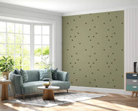 Green polka wallpaper showing soft rounded motifs and easy visual rhythm