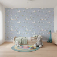 Mother duck and ducklings stride past daisies on the Baby Ducklings wallpaper