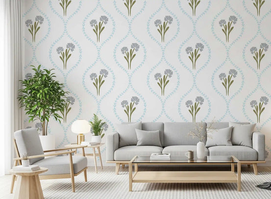 Cornflower trellis wallpaper behind a low sofa in a soft-toned living room