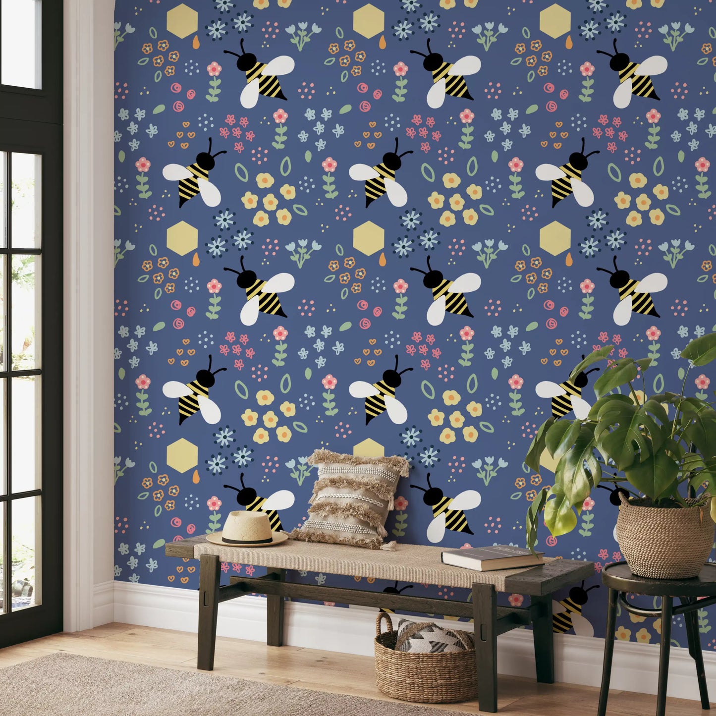 Living room corner styled with the bee wallpaper above a low bed
