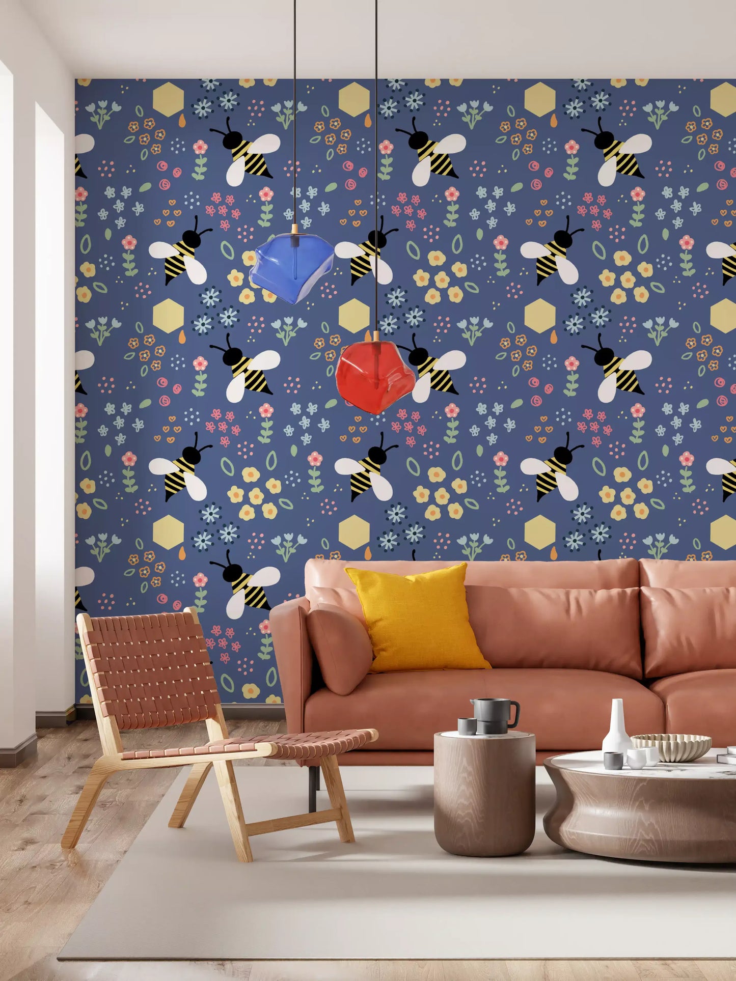 Navy bee and floral wallpaper behind a tan leather sofa in a living room
