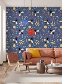 Navy bee and floral wallpaper behind a tan leather sofa in a living room
