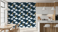 Kitchen and dining room opening onto a moon and cloud wallpaper in deep navy