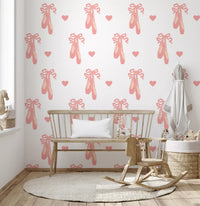 Pink slippers and small bows scatter on Sweet Ballet Dreams wallpaper inside a nursery.