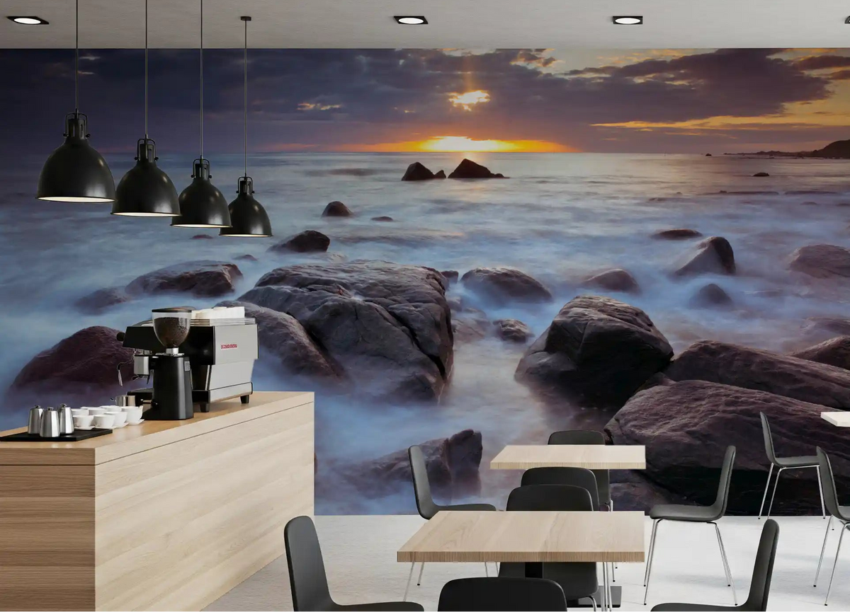 Sunset coastal scene spreading across a café seating area as a wall mural