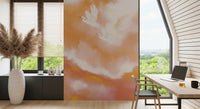 Warm coral wall mural with flying herons styled in a Home office 