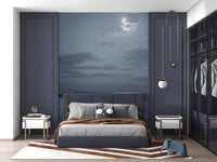 Moonlit Ocean Serenity wall mural set behind a bed in a deep blue bedroom